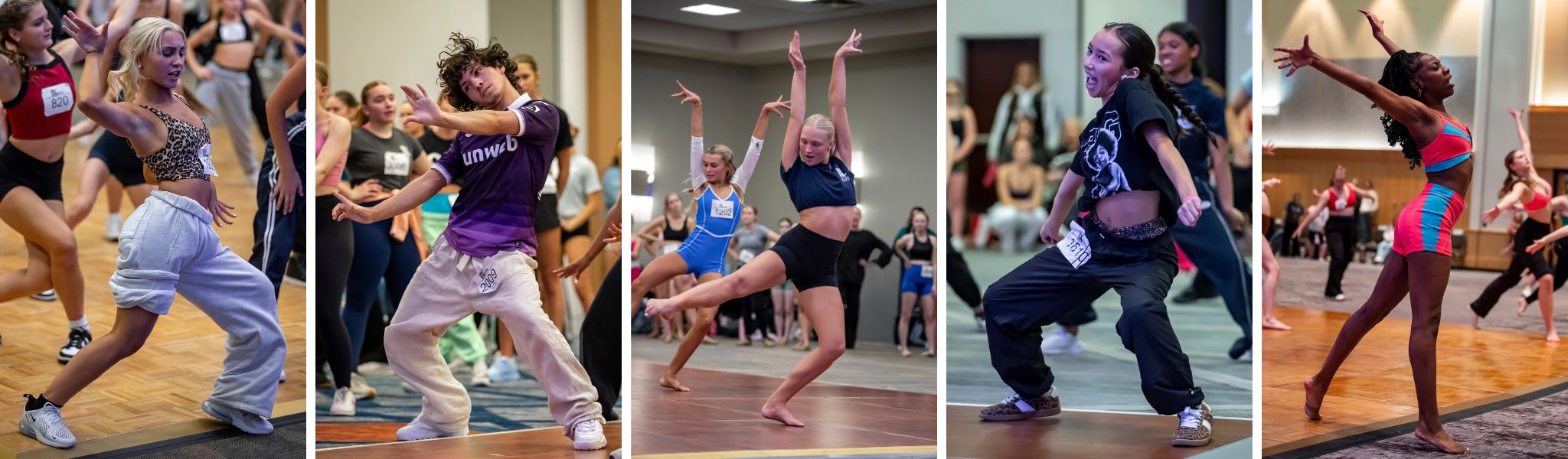 Five dancers, each in different poses and outfits, energetically perform in a dance studio with an audience and other dancers watching in the background.